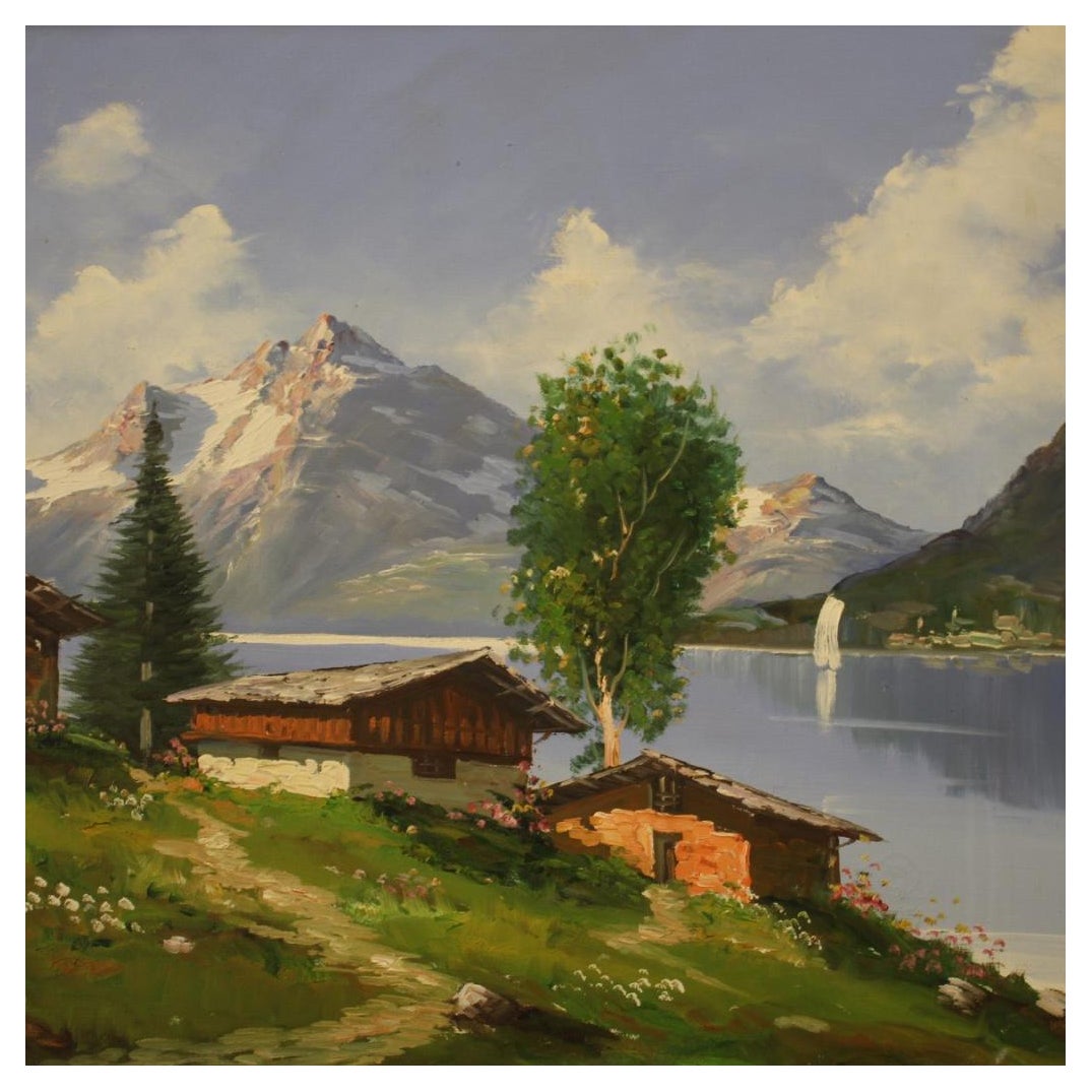 Italian painting from the second half of the 20th century. Artwork oil on canvas depicting a view of a mountain lake with a good pictorial quality. Beautifully sized and pleasantly furnished painting adorned with a carved and gilded wooden frame