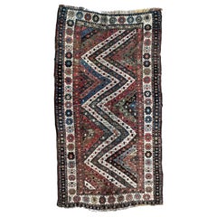 Antique Tribal Caucasian Kazak Rug with Geometric and Floral Pattern