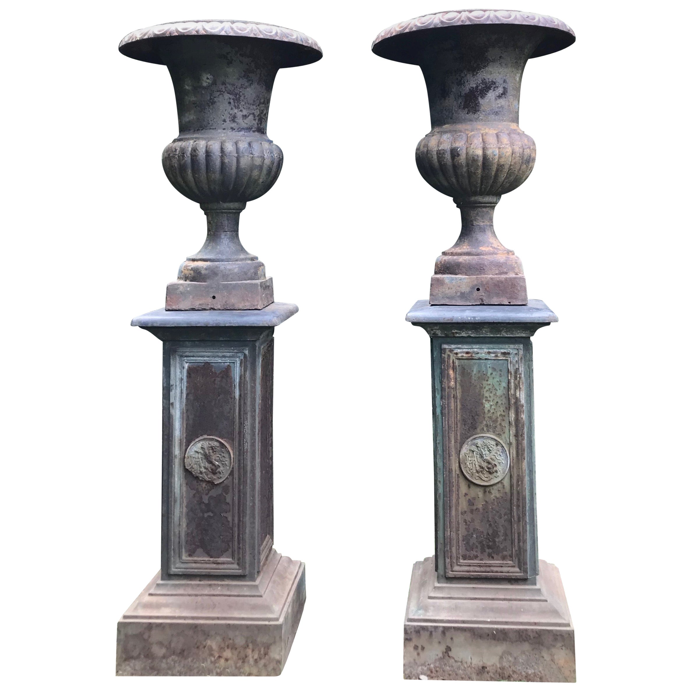 Pair of Tall Cast Iron Medici Urns on Pedestals with French Republic Medallions For Sale