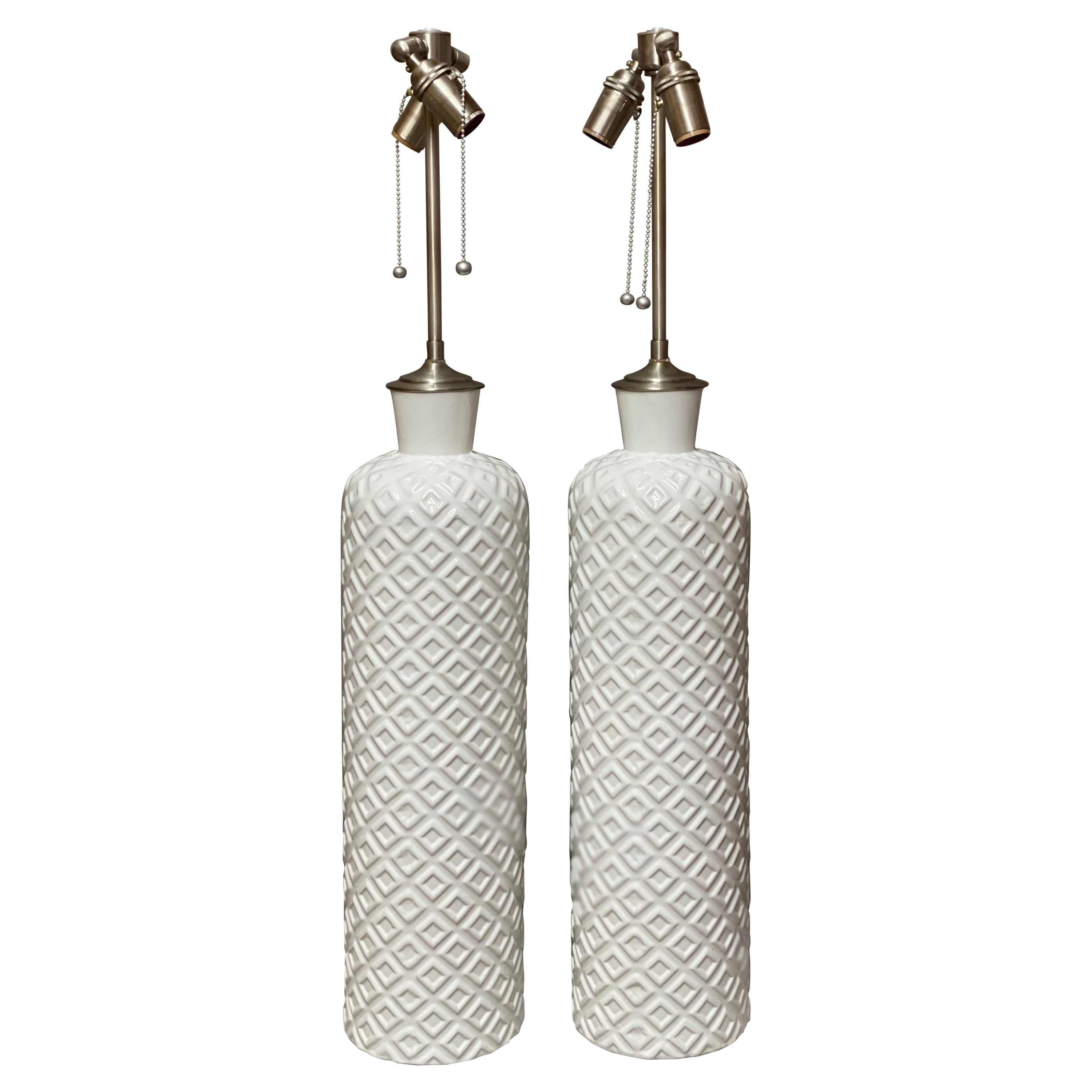 Pair of Great Tall Chic Embossed Ceramic White Vessels with Lamp Application For Sale