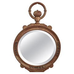 Miroir à enseigne d'horloger et de bijoutier en fonte double face