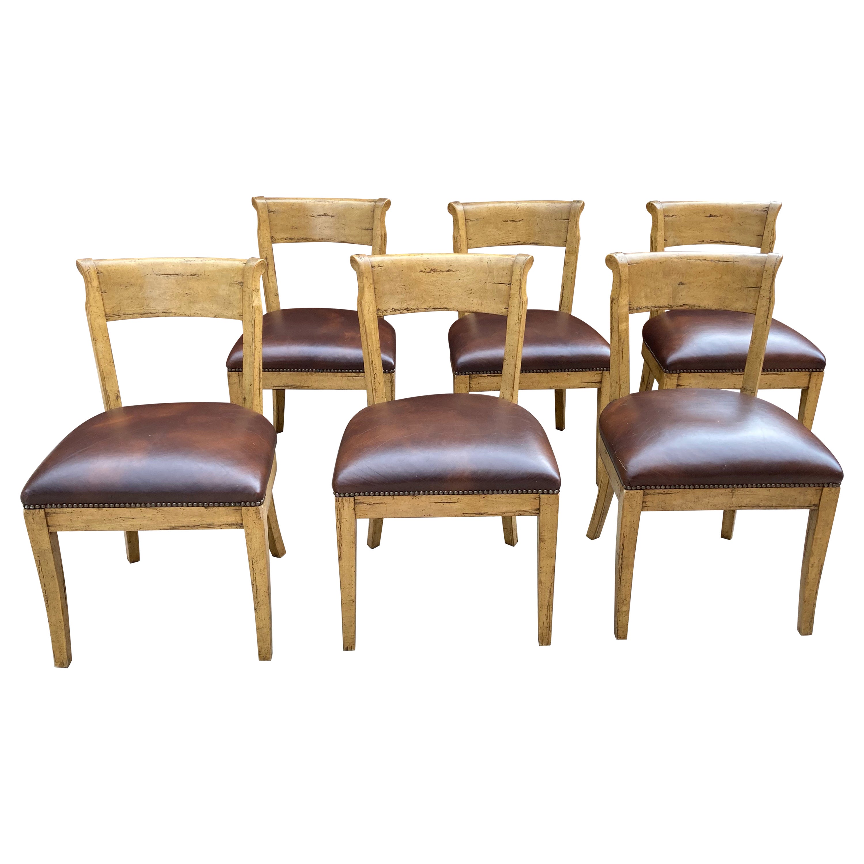 Fantastic set of 8 Guy Chaddock country French style chairs with beech wood frames and leather seats. 6 side chairs and 2 arm. 
Good condition with some blemishes on seat leather as shown in close-ups. No rips or tears, only a scrape here and there