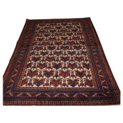 Ancien tapis Afshar à motif de bouclier répétitif sur fond ivoire