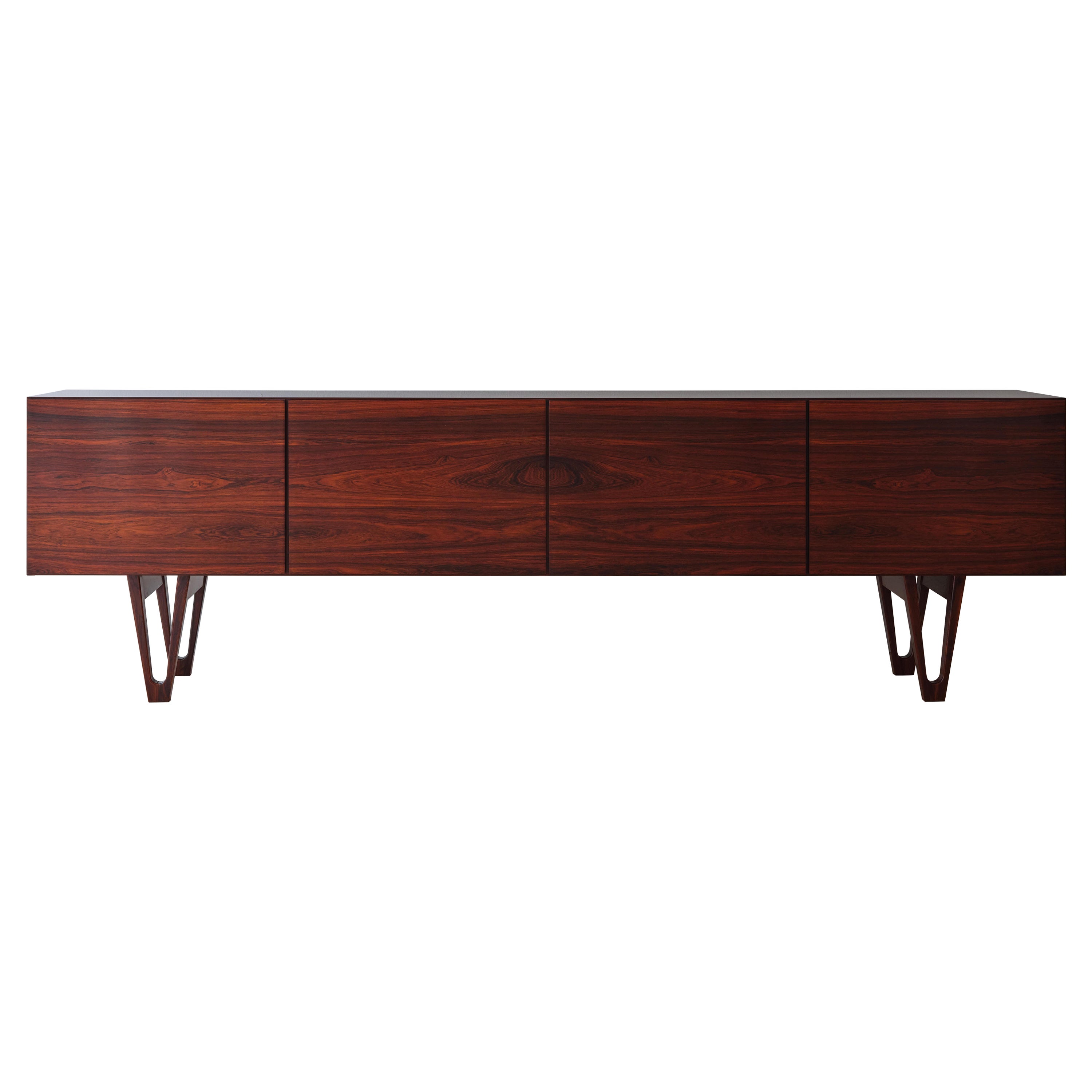 A rare Rio Palisander sideboard designed by Danish designer Ib Kofod Larsen and Produced by Seffle Möbelfabrik, Sweden, Circa 1959-1965. The dramatic figured Rio palisander applied on this long low and simple style sideboard creates an elegant piece