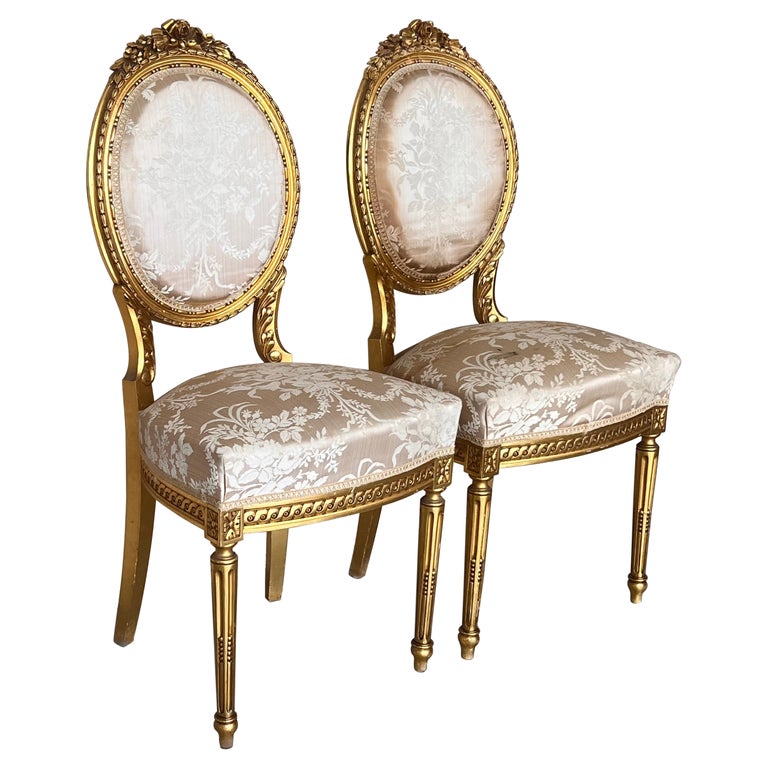 Pair of Antique French Louis XVI Style Parcel Gilt and Painted Dining Chairs For Sale