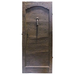 Vintage walnut entrance door in rustic style, with nails, 18th century Italy