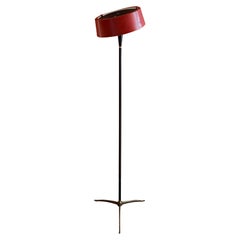 1950's Italian black and brass floor lamp with tilting red shade, manner of Lumi