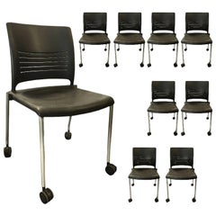Used Dark Grey Plastic Chair with Metal Legs and Casters