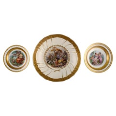 Three Royal Copenhagen bowls decorated with flowers and romantic scenery. 