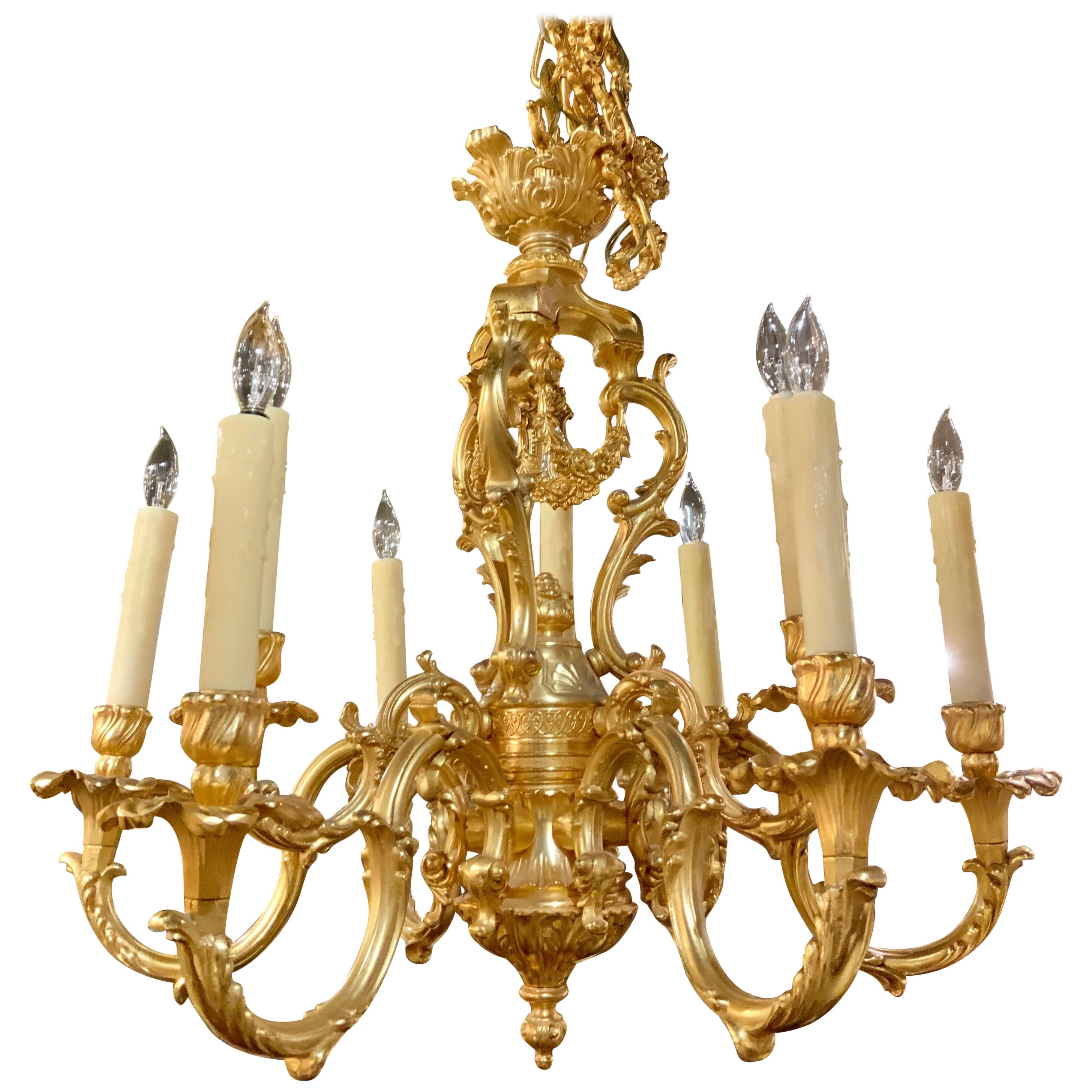 French Gilt bronze chandelier in the Louis XV taste, nine light with floral swag For Sale