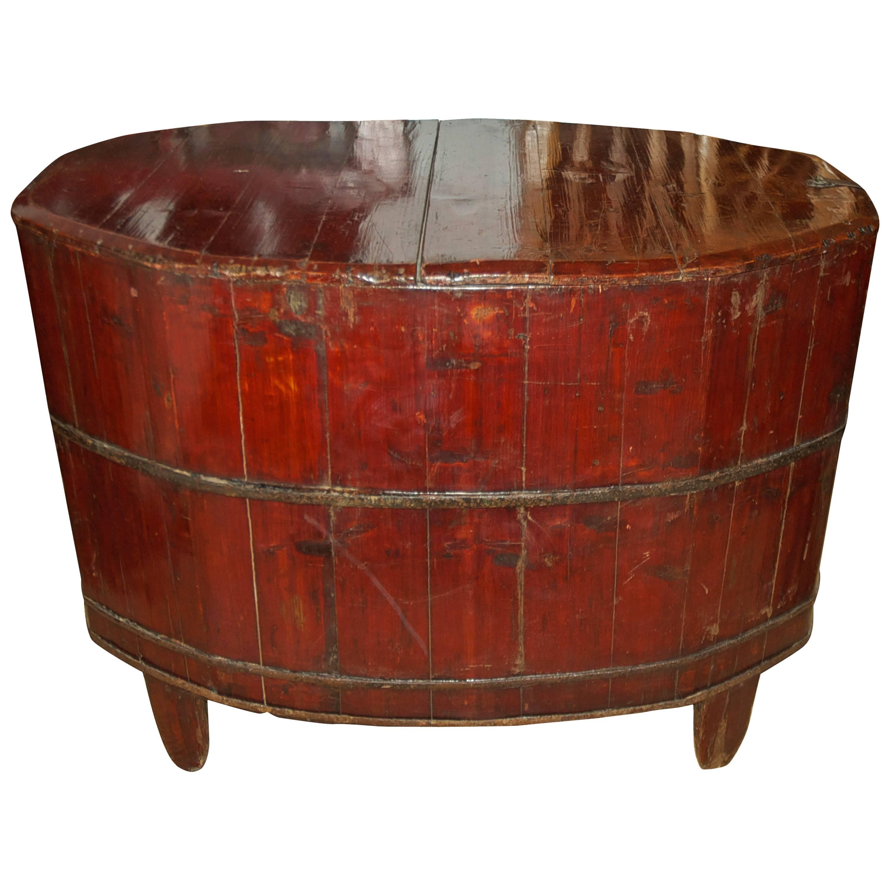 A storage container for rice or wheat in lacquered wood (probably elm) with cinnabar-colored paint on tapered feet, with lift-top and iron side pulls. China, circa 1800s. Makes a lovely end table, coffee table and an interesting conversation