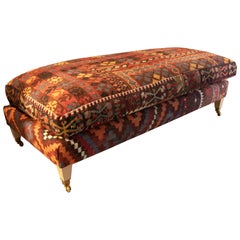 Antique Kilim Upholstered Pouffe with Four Wooden Legs and Brass Castors