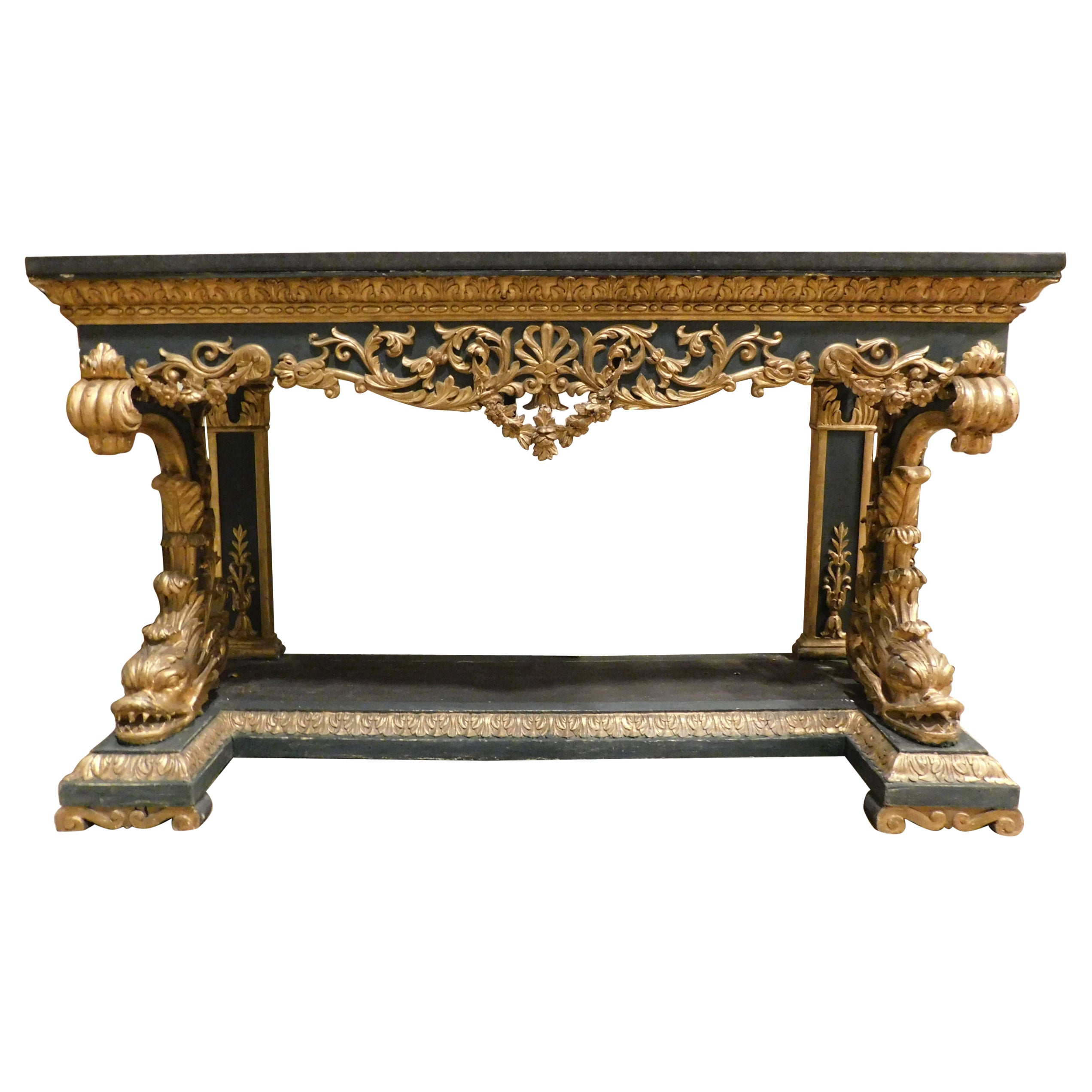 Gilded and lacquered console in richly carved wood, black marble top, Italy For Sale