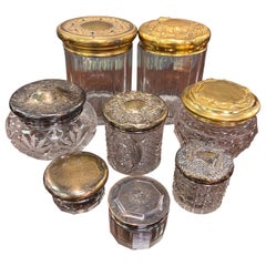 Grouping of 8 Cut Glass Jars with Sterling and Brass Lids