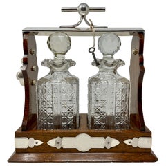 Antique English Silver Plate, Oak and Cut Crystal 2 Bottle Tantalus, Circa 1890.