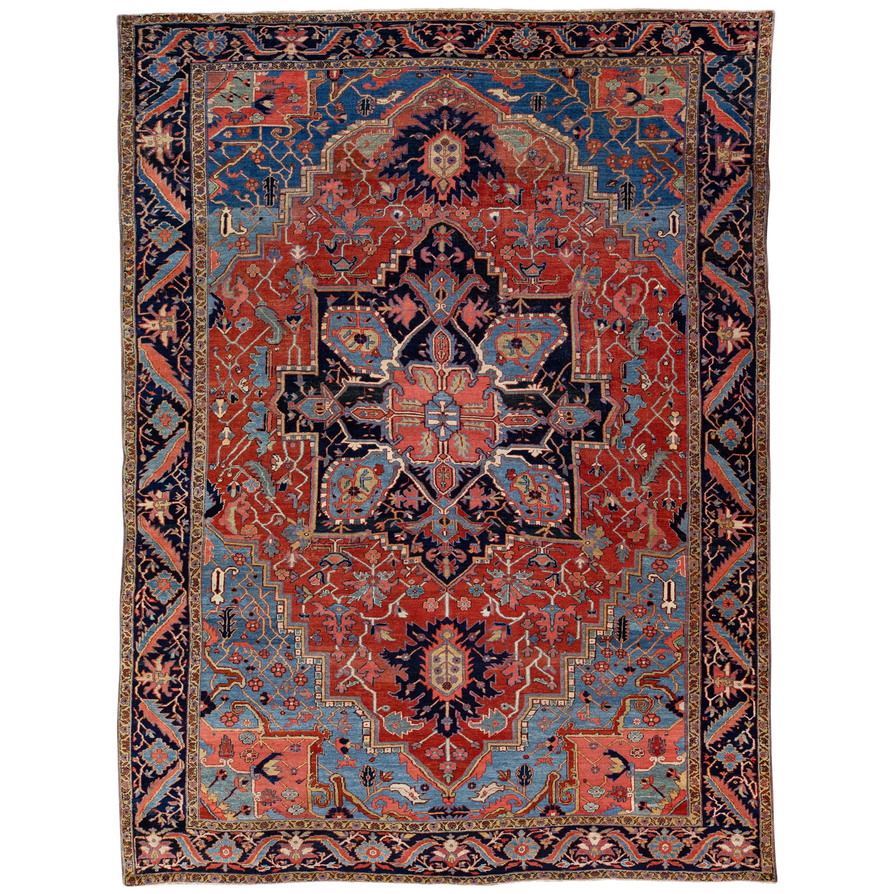 Antique Persian Heriz Handmade Red & Blue Wool Rug with Medallion Design For Sale