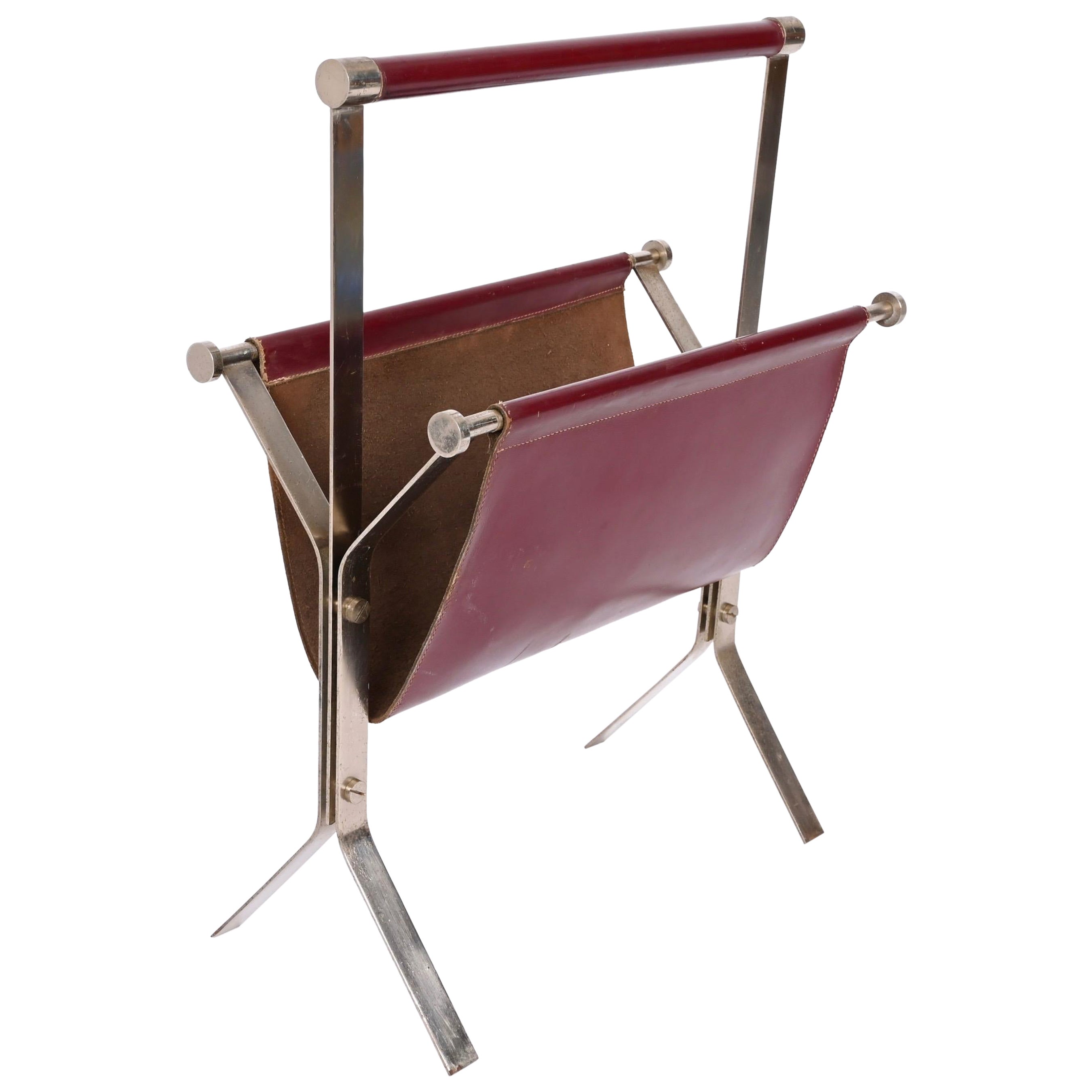 Amazing Midcentury chromed steel and red leather magazine rack. The famous Venetian designer Alessandro Albrizzi designed this piece in Italy during the 1970s.

This fantastic piece combines elegant burgundy red leather with chrome structure. This