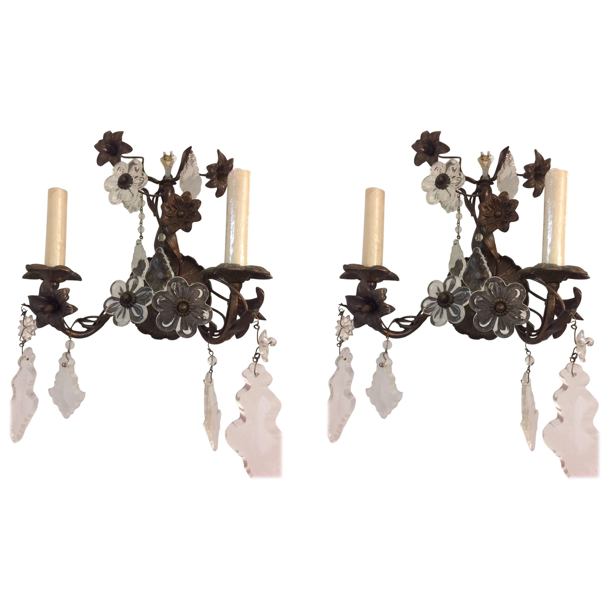 Pair of patined bronze two lights sconces with molded floral and foliage motif.

Measure: 15