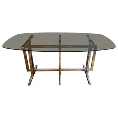 Vintage dining table. Graphic feet in chrome metal. Smoked glass top.