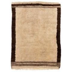 Alfombra Tulu Vintage hecha a mano en lana turca, beige con borde marrón, 4,4x5,5 pies