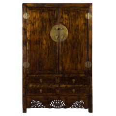 Tall Brown Wood Armoire with Brass Hardware and Carved Skirt Panel