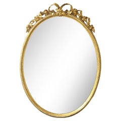 French Oval Gilt Mirror with Bow Crest, 1860