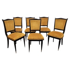 Set of six French ebonized dining chairs with nickeled sabots