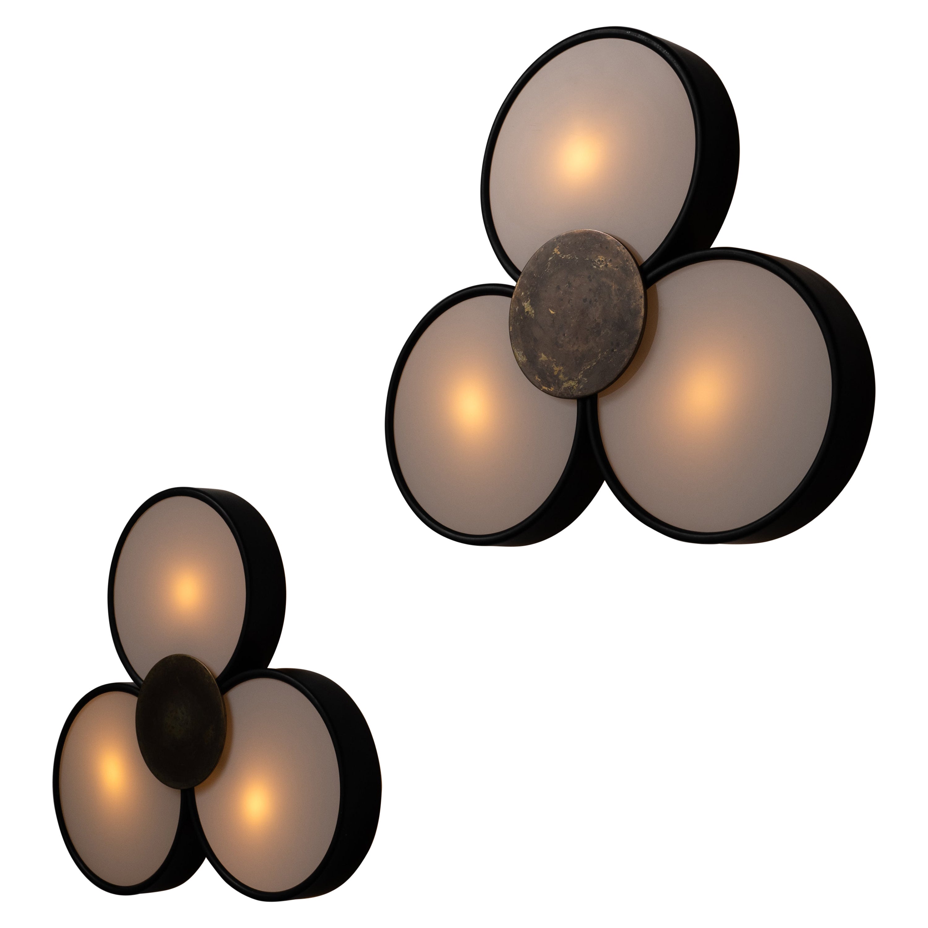 Italian flush Mount ceiling lights. Designed and manufactured in Italy, circa the 1960s. Three translucent glass petals are framed around a black rim. An aged brass button is at the center finishing the detail on these sconces. We recommend three