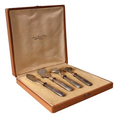 Silver and gold metal serving cutlery in their box