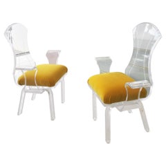 Used Lucite wing-arm dining or side chairs with yellow velvet seat pads, USA 1980s