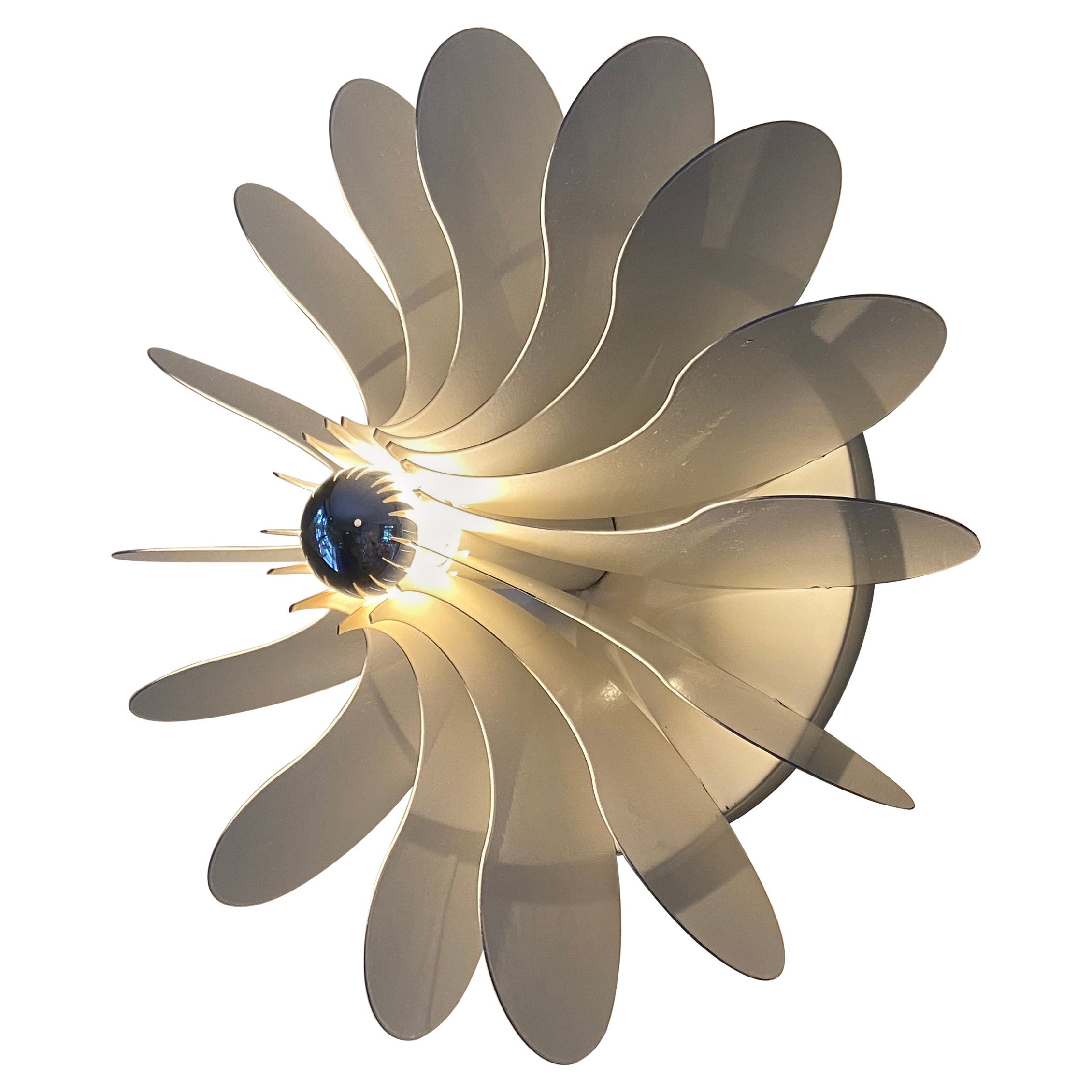 Raak Bolide, designed by Hermian Sneyders de Vogel in the 1970s. Elegant and organic shape. When you look closely you will see one half of the yin yang sign mounted 16 x in a flower shape on this lamp. (this designer also designed the YinYang lamp