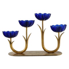 Gunnar Ander for Ystad Metall. Candlestick in brass and blue art glass.