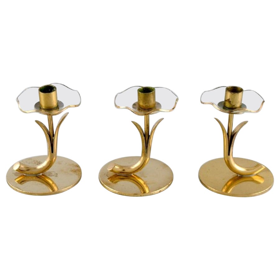 Gunnar Ander for Ystad Metall, Three Candlesticks in Brass and Clear Art  Glass For Sale at 1stDibs