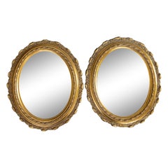 Paire de miroirs ovales italiens en bois doré et gesso du milieu du siècle dernier, vers 1950