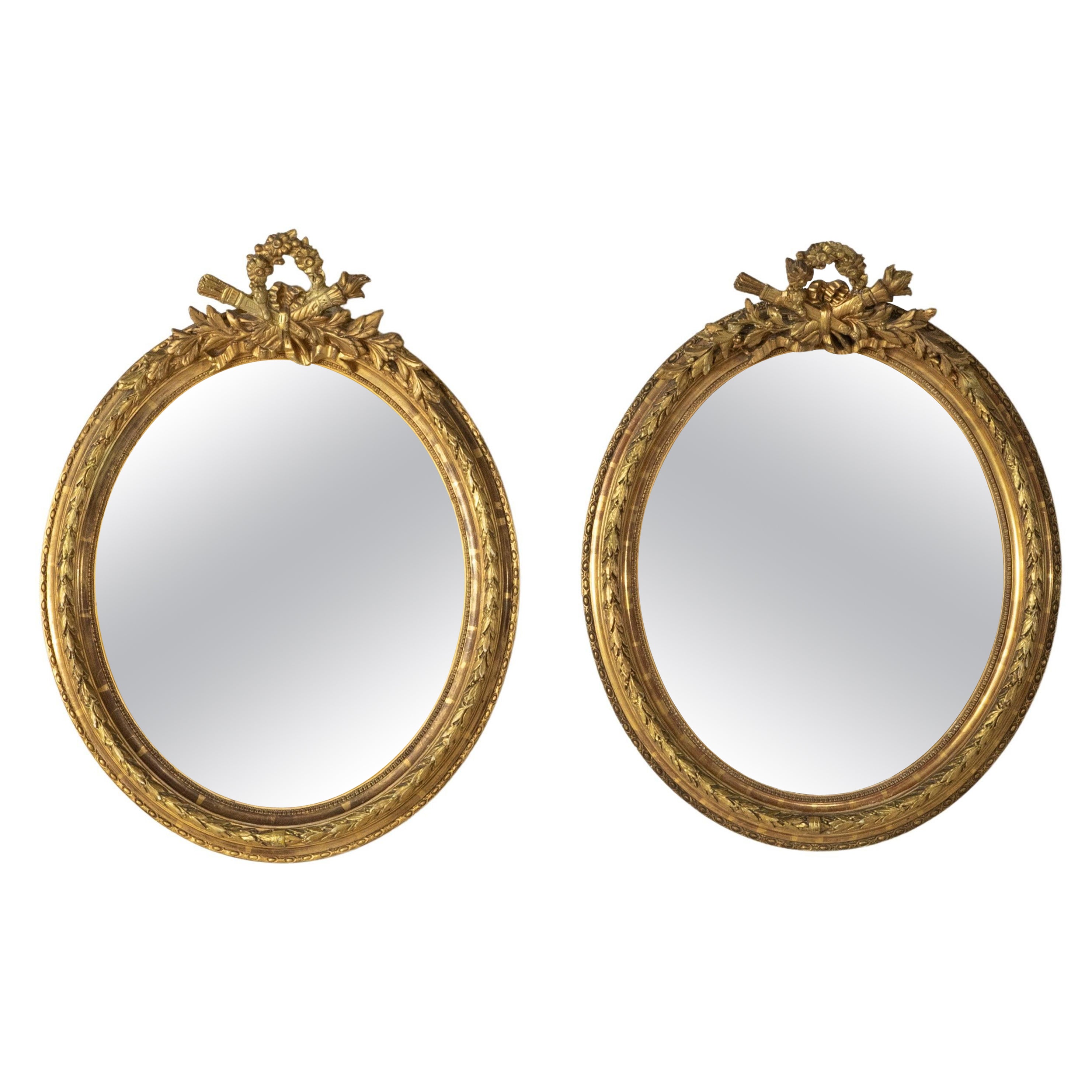 Pair of Late 19th Century French Louis XVI Style Oval Gilt Wood Mirrors 