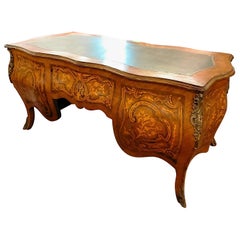 Antique French center room desk inlaid and move top in leather and bronze profiles