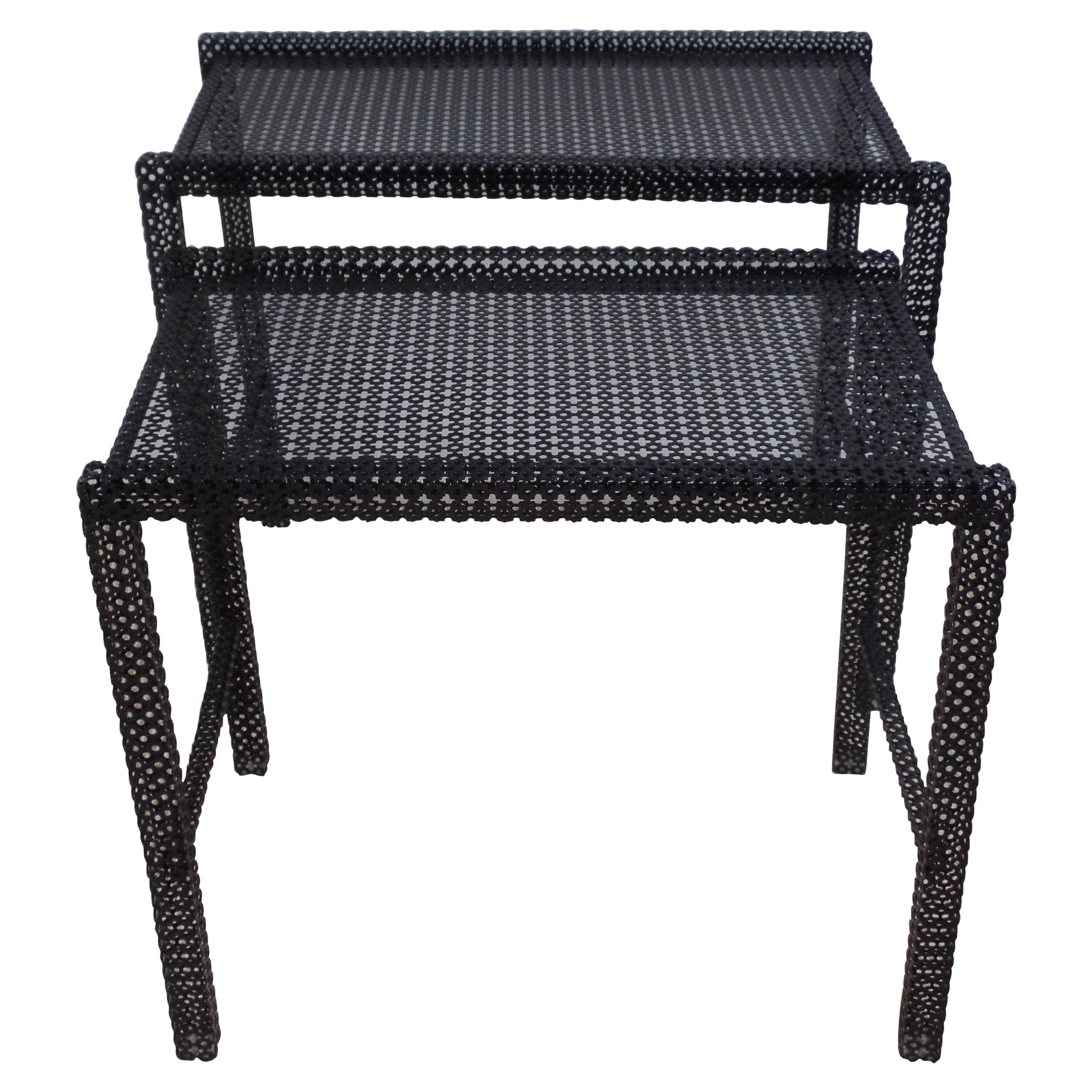 Rare and Elegant pair of French Mid-Century Modern nesting/ side tables or cocktail tables in perforated steel by Mathieu Matégot. The pieces are enameled black. The tables represent the essence of the modernist aesthetic: rational and quadratic