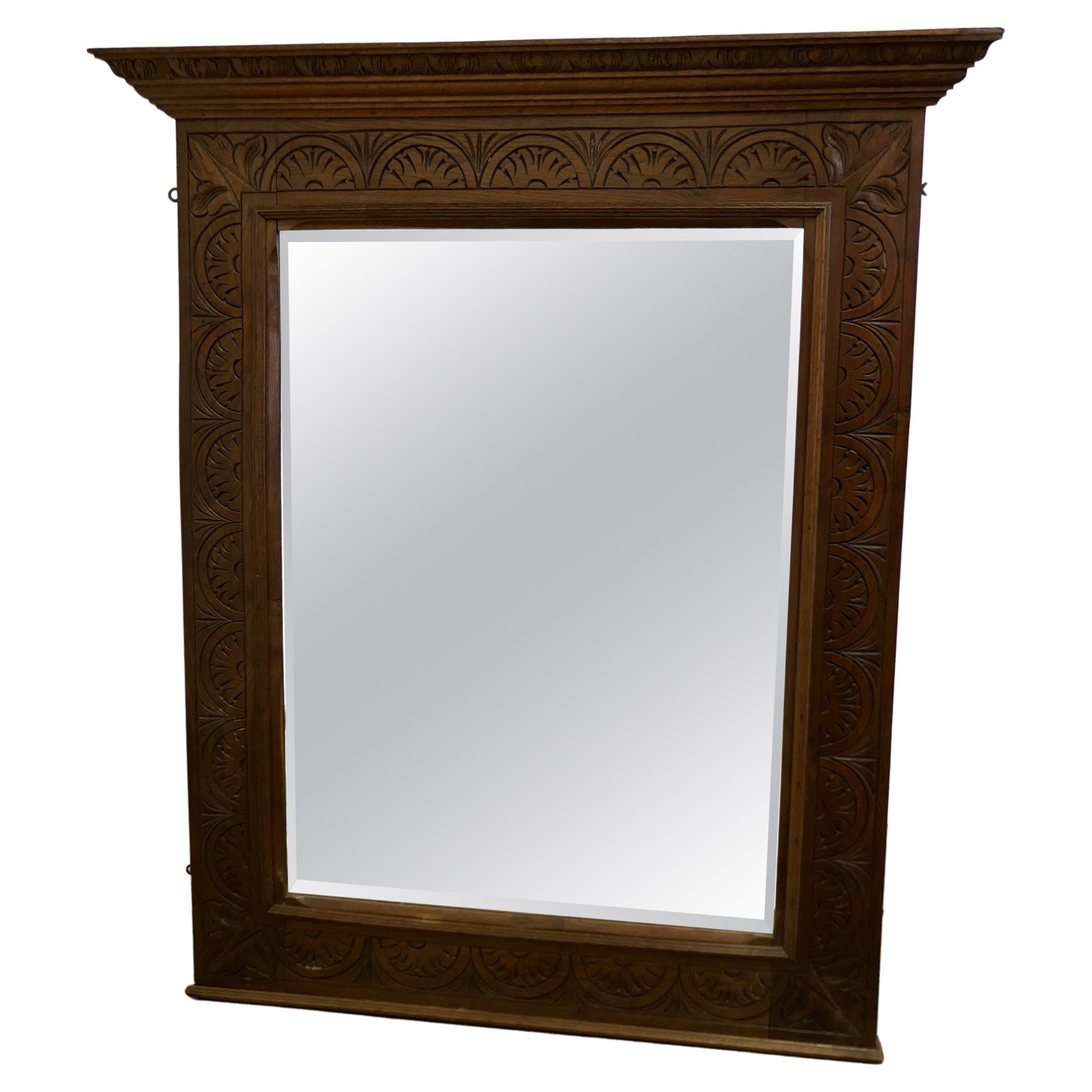 A Very Large Carved Oak Overmantel or Wall Mirror    