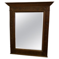 A Very Large Carved Oak Overmantel or Wall Mirror    