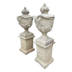 Pair of Lidded French Garden Urns with Rams Heads and Grape Vines on Pedestals