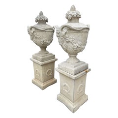 Pair of Lidded French Garden Urns with Rams Heads and Grape Vines on Pedestals