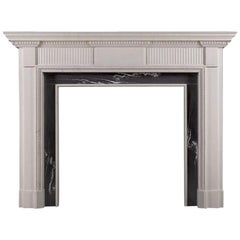 An elegant neoclassical style limestone fireplace, reflecting the designs of the