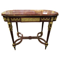 A fine 19th c French Louis XVI mahogany and gilt bronze mounted centertable