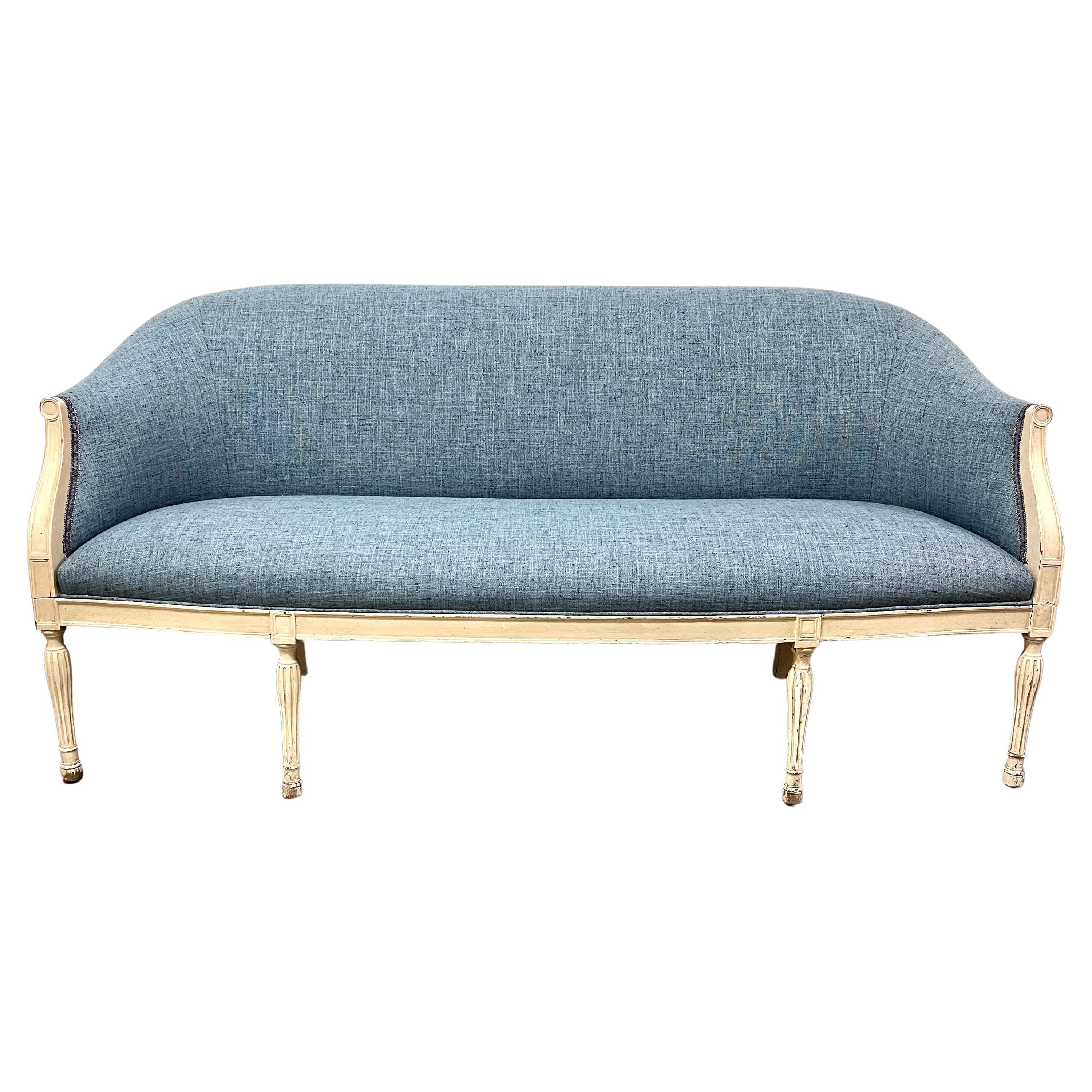 A Louis XVI Style Sofa - the frame is patinated wood with new Beautiful Blue upholstery... the trim is in a blue gray gimp... a stunning piece and a compliment to the Bedroom, guest room, or den. Very comfortable and works in spaces from traditional