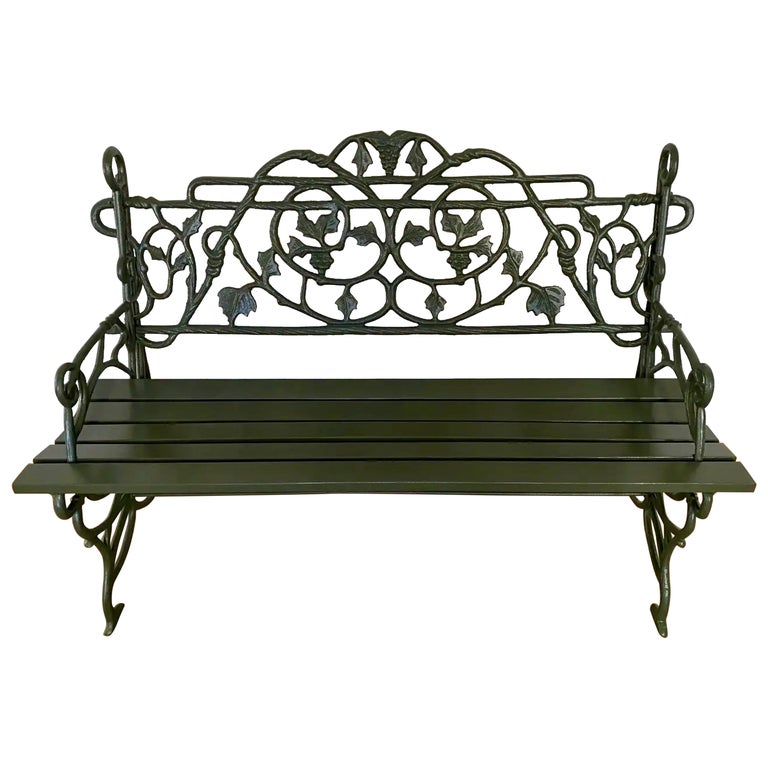 Early 20th Century Painted Cast Iron Garden Bench with Vine Motif For Sale