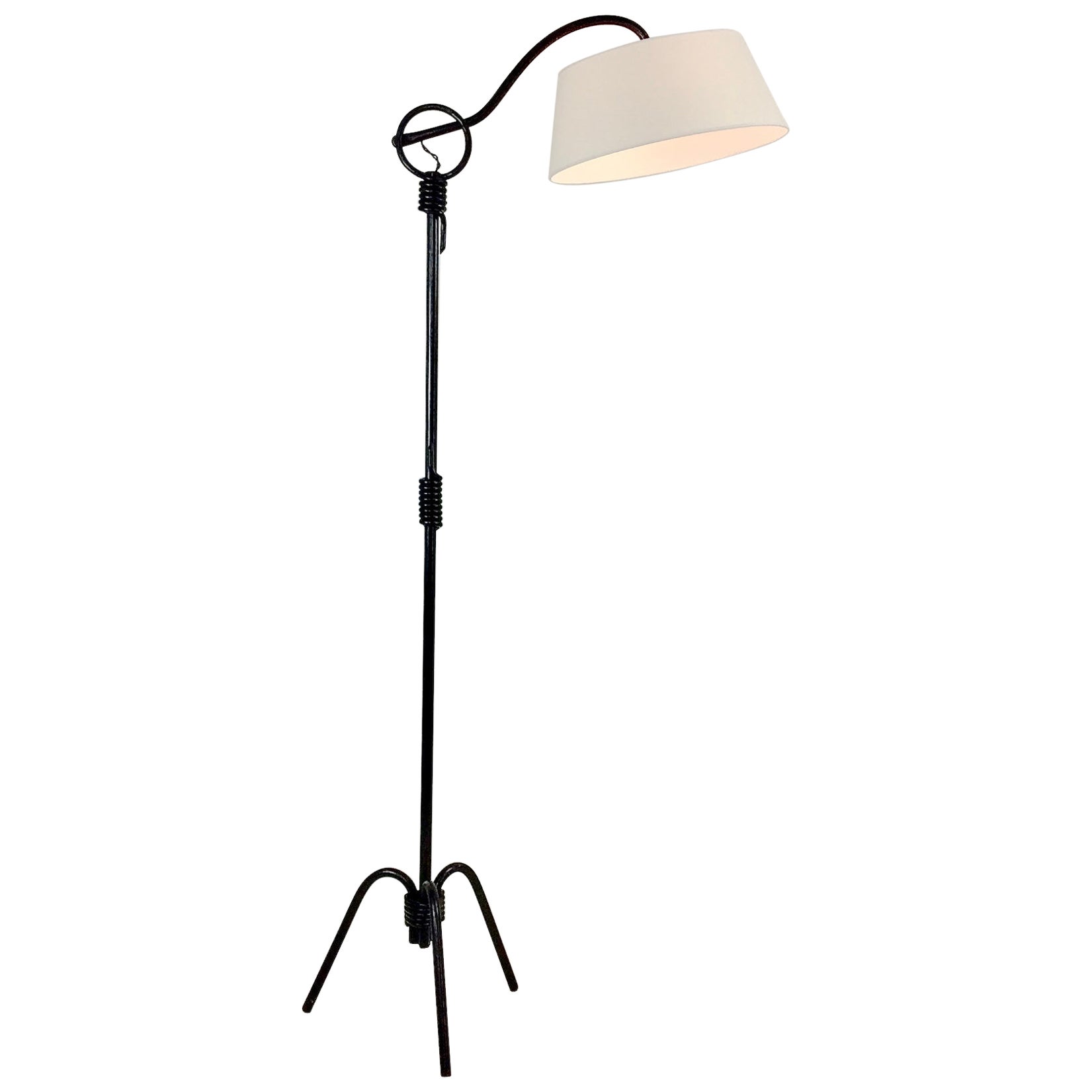 Mid-Century Modern adjustable floor lamp, attributed to Jacques Adnet, circa 1950, France.
Black enameled tubular metal, new white fabric shade.
The arm can be adjusted to five hooks points.
Rewired.
Dimensions: maximum height: 190 cm, 73 cm W,