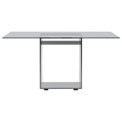 Acerbis Judd - Grande table carrée, plateau en verre transparent et base en acier brillant