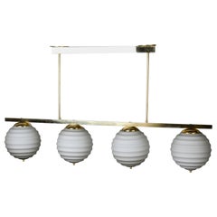 New Italian Fixture with Four Pale Taupe Globes on Horizontal Brass Bar