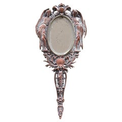 Antique 20th Century French Hand Mirror with Two Angels Surrounding the Oval Shape