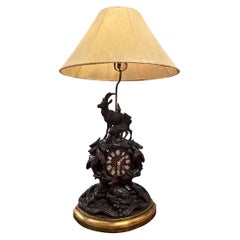 Lampe montée sur horloge allemande du 19e siècle, sculptée en Black Forest, avec abat-jour en peau de vache